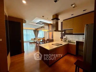 Spacious open-layout kitchen and living area with modern design and natural light.