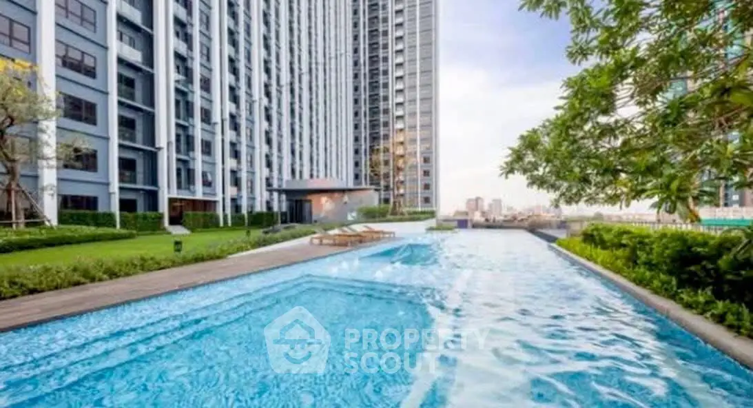 Luxurious high-rise building with stunning pool and lush garden view.