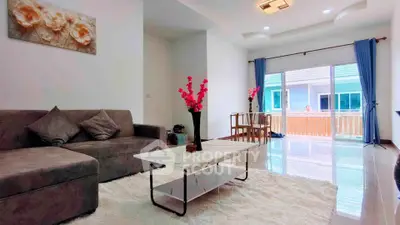 Spacious living room with modern decor and large windows for natural light.