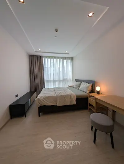 Modern bedroom with sleek design, featuring a comfortable bed, stylish furniture, and large window for natural light.