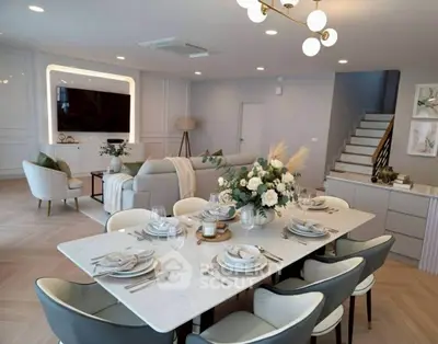 Elegant open-plan living room with modern dining area and stylish decor