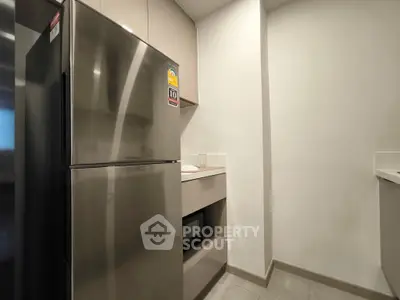 Modern kitchen with stainless steel fridge and sleek cabinetry