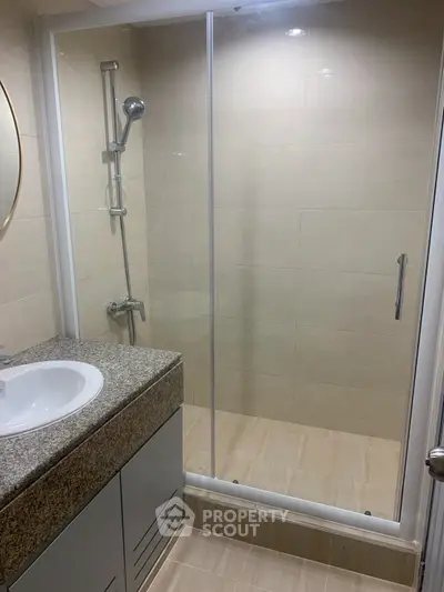 Modern bathroom with glass shower and granite countertop