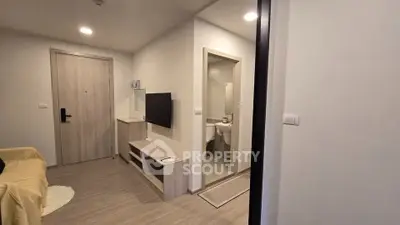 Modern apartment entrance with cozy living area and bathroom view