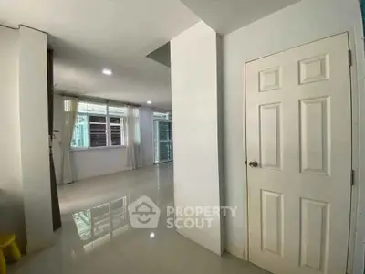Spacious modern interior with glossy floors and ample natural light, perfect for stylish living.