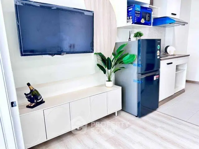 Modern kitchen with sleek appliances and stylish decor in a contemporary apartment.