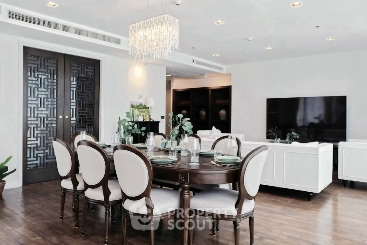 Luxurious open-plan living and dining area with elegant furniture and modern decor