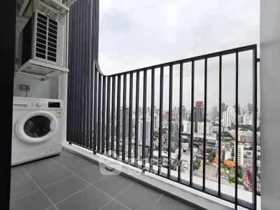 High-rise balcony with city view and washing machine, perfect for urban living.