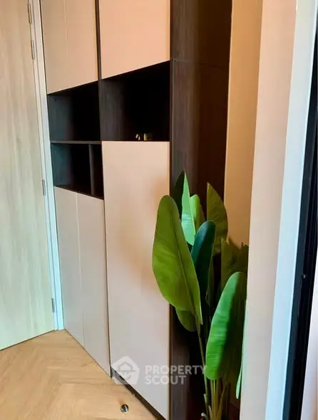 Modern interior with stylish storage and decorative plant in a cozy corner.