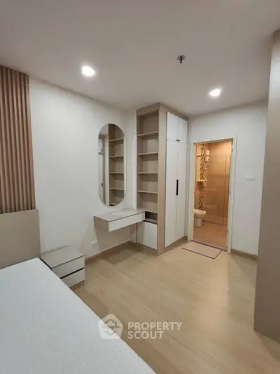 Modern bedroom with built-in storage and ensuite bathroom