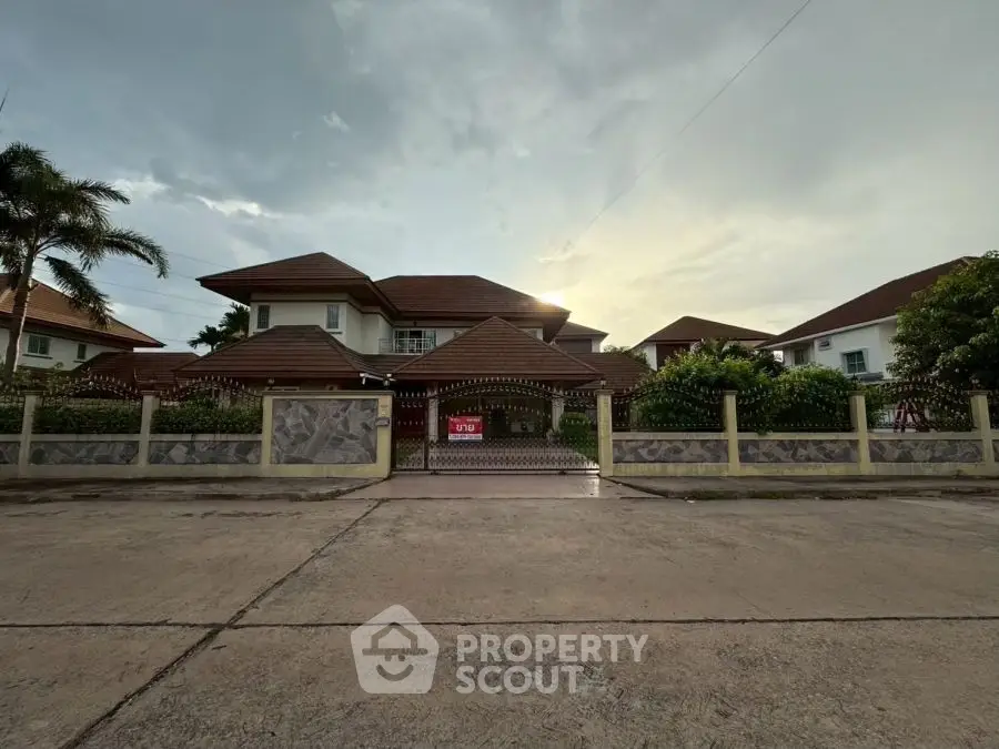 Stunning two-story house with a spacious driveway and lush greenery, perfect for family living.