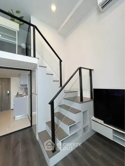 Modern duplex apartment with sleek staircase and open kitchen layout