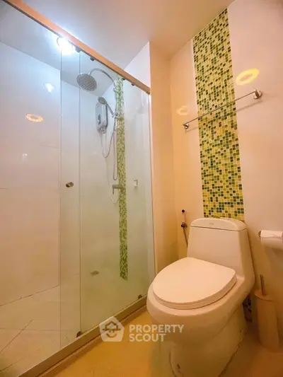 Modern bathroom with glass shower and mosaic tile accent wall