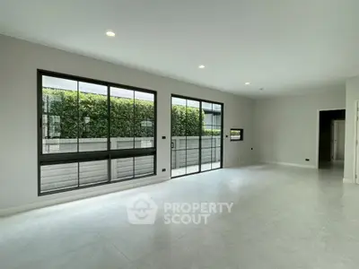 Spacious modern living room with large windows and garden view