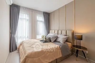 Luxurious bedroom with elegant decor and natural light, featuring plush bedding and stylish curtains.