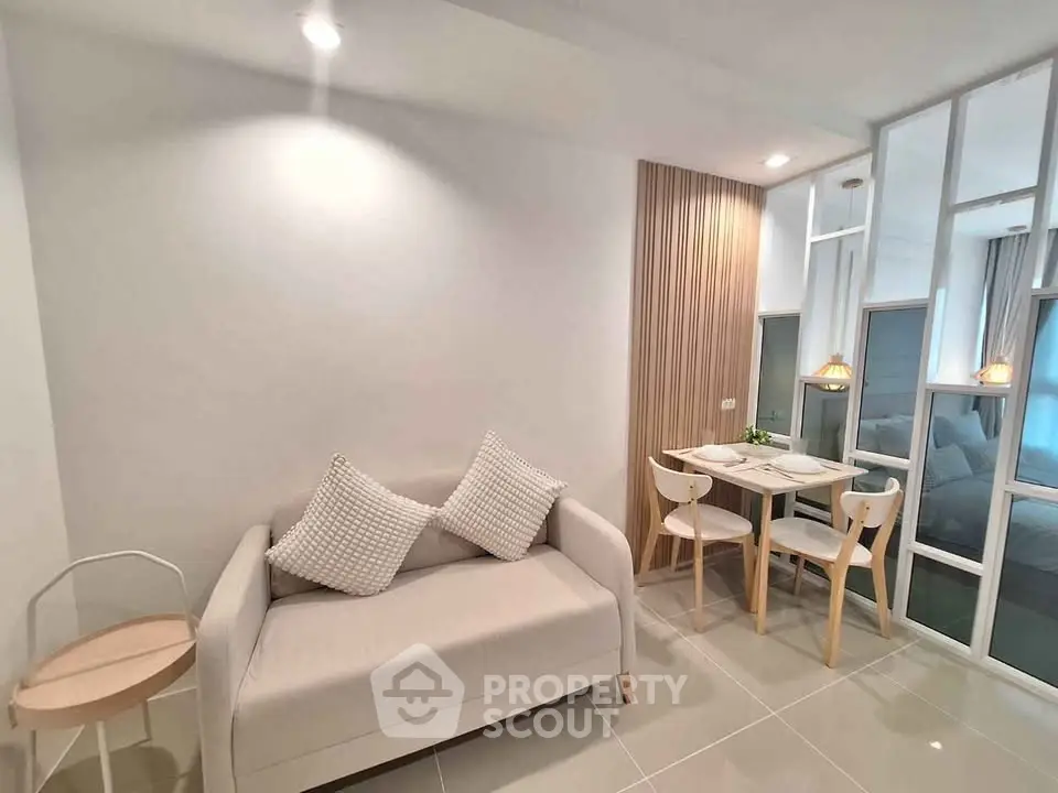 Modern living room with cozy sofa and dining area in stylish apartment.