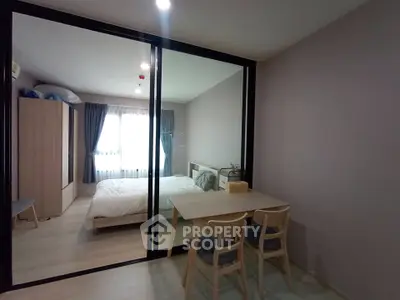 Modern bedroom with glass partition and cozy dining area