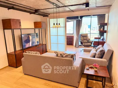 Spacious modern living room with stylish furniture and city view, perfect for urban living.