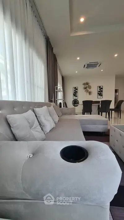 Luxurious living room with plush sofa and elegant dining area, perfect for modern living.