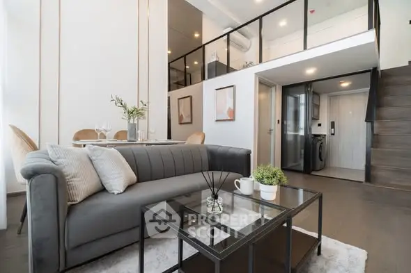 Modern loft-style living room with elegant decor and mezzanine level