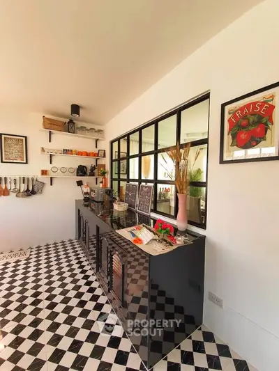 Chic kitchen with black and white checkered floor, sleek cabinets, and stylish decor.