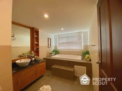 Luxurious bathroom with elegant bathtub and modern fixtures in a spacious setting.