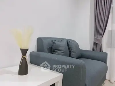 Modern living room with stylish gray armchair and elegant decor