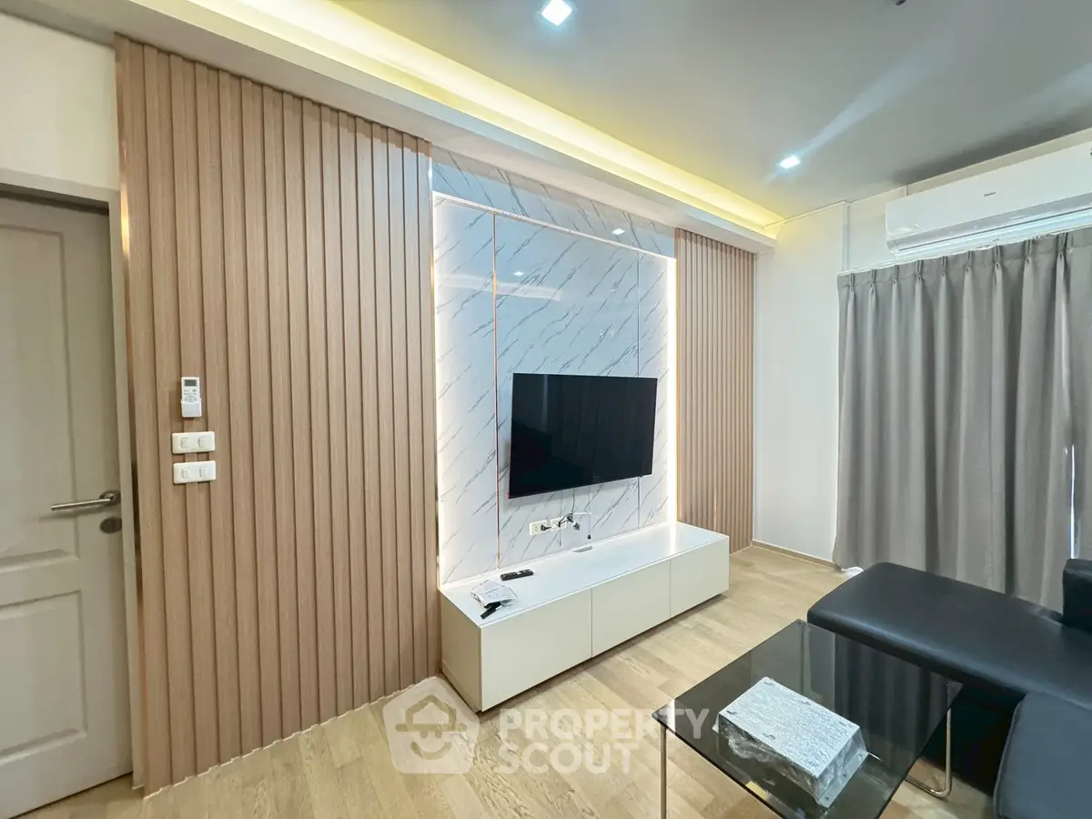 Modern living room with stylish TV wall and sleek furniture