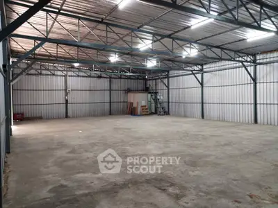 Spacious industrial warehouse with high ceilings and ample storage space.