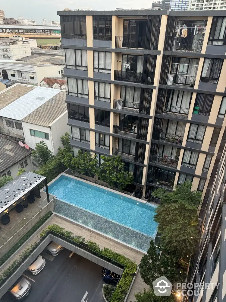 Modern condominium with pool view and cityscape in urban setting