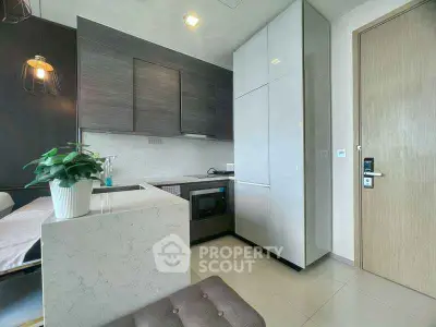 Modern kitchen with sleek cabinetry and built-in appliances in a stylish apartment.