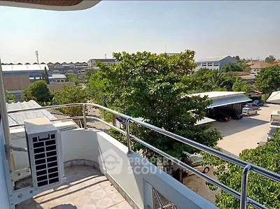 Spacious balcony with scenic view of lush greenery and urban landscape, perfect for relaxation and outdoor enjoyment.