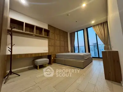 Modern bedroom with city view, featuring wooden accents and large windows.