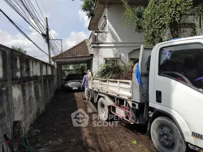 Spacious driveway with truck and greenery at suburban home