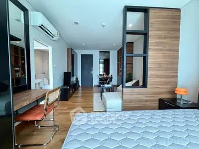 Modern apartment interior with stylish furniture and open layout, featuring a cozy living area and wooden accents.