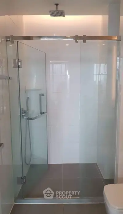 Modern bathroom with glass shower enclosure and sleek fixtures