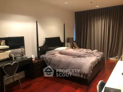 Luxurious bedroom with elegant decor and rich wooden flooring