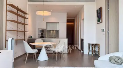 Modern open-plan kitchen and dining area with stylish furniture and sleek design.