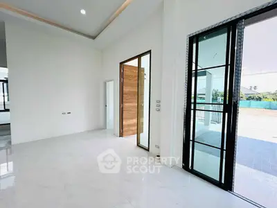 Spacious modern living room with large windows and elegant tile flooring