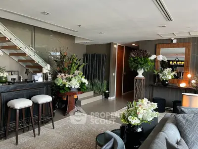 Luxurious living room with elegant decor and modern staircase