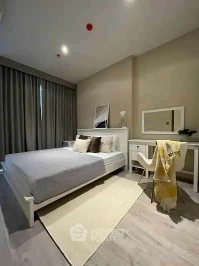 Modern bedroom with stylish decor and cozy ambiance, featuring a comfortable bed and elegant furnishings.