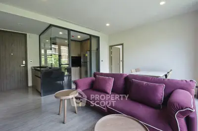 Modern living room with purple sofa and open kitchen in a stylish apartment