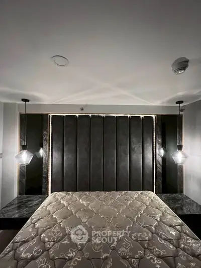 Luxurious bedroom with elegant lighting and plush headboard