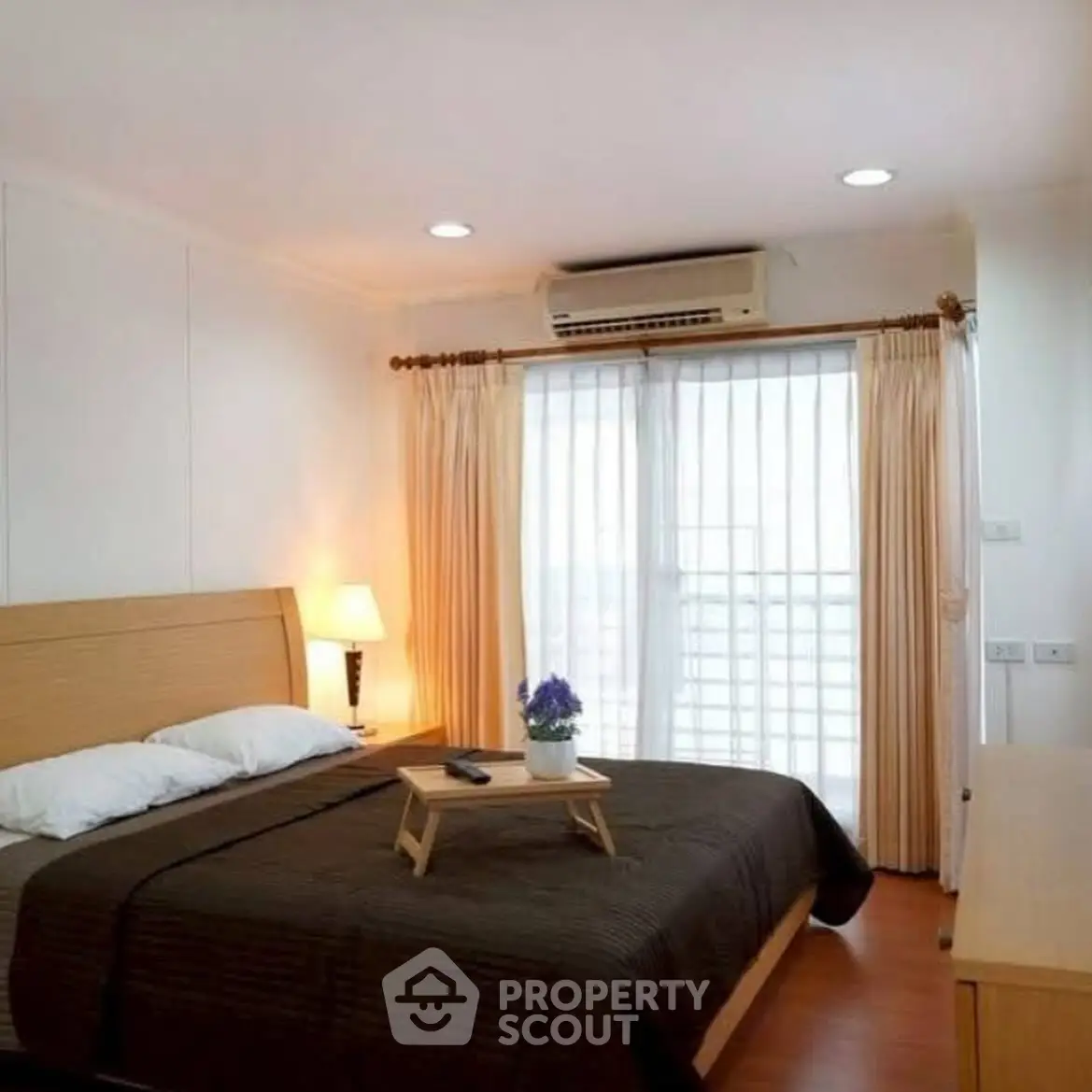 Cozy bedroom with natural light and modern decor, featuring a comfortable bed and elegant curtains.