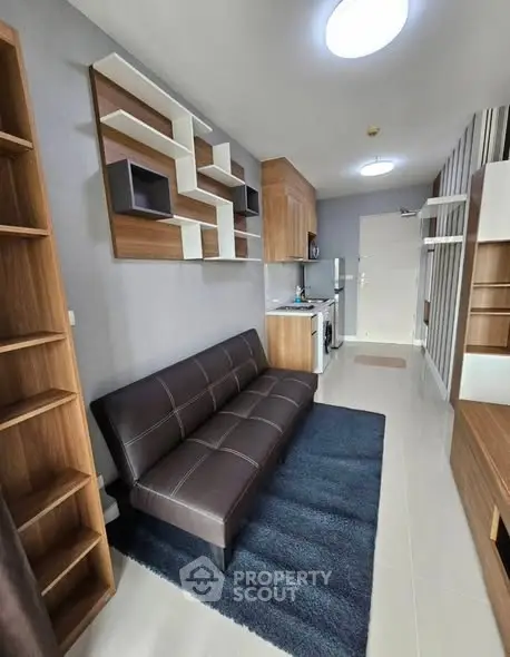 Modern studio apartment with stylish furniture and open kitchen layout