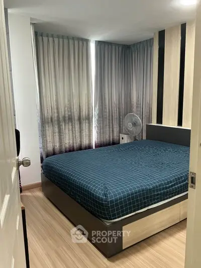 Cozy bedroom with modern decor and large windows for natural light