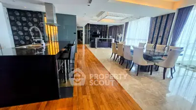 Luxurious open-plan living and dining area with modern kitchen and elegant decor