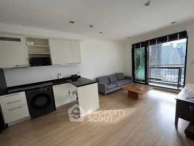Modern open-layout living room with kitchen and city view