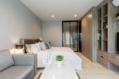 Modern bedroom with cozy decor and stylish furniture in a contemporary apartment.