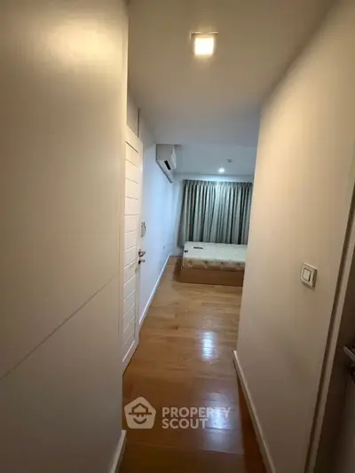 Cozy bedroom with wooden flooring and natural light